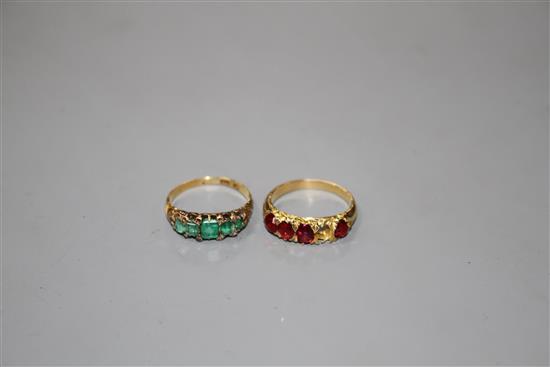 A George V yellow metal, graduated five stone emerald and diamond chip ring and one other four(ex five) stone ring.